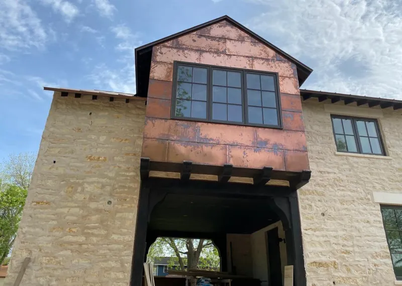 Copper metal panel facade on a stone building for Metal Roof Coating in Gillette